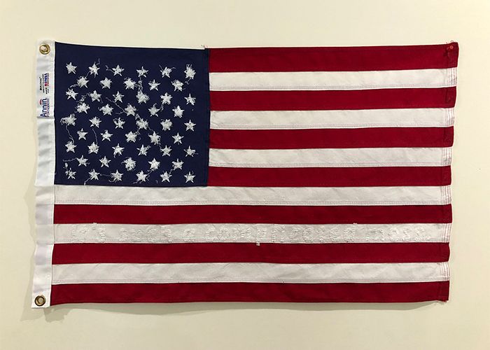 American (a complicated mess), 2022 (Embroidery on altered American flag, 3 by 2 feet) by Michele Jaquis. (“It’s such a complicated mess” is a quote from the We Are All Americans podcast, season three, episode two. with Beverly Naidus).