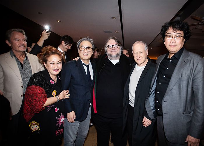 Miky Lee in a group shot with film directors Bong Joon-ho and Guillermo del Toro